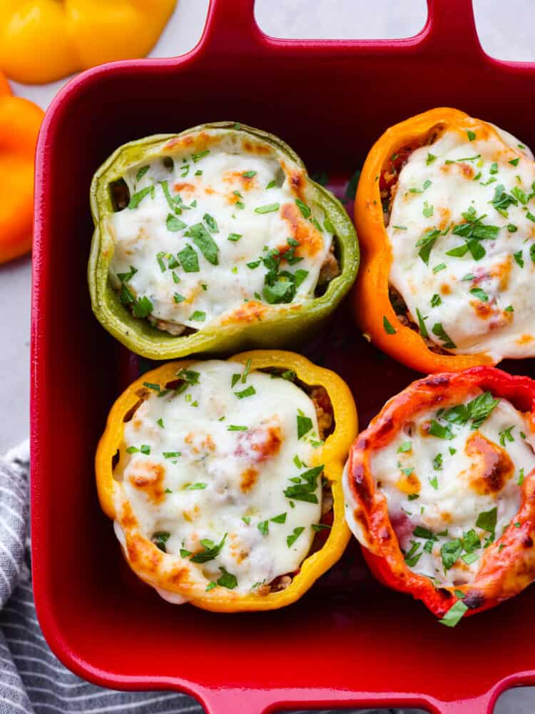 Turkey stuffed peppers combine ground turkey, tons of vegetables, and pepper jack cheese into a satisfying and healthy low-carb meal. Jumpstart your healthy eating habits with these oh-so-delicious stuffed peppers! Closeup of 4 turkey and cheese stuffed peppers.