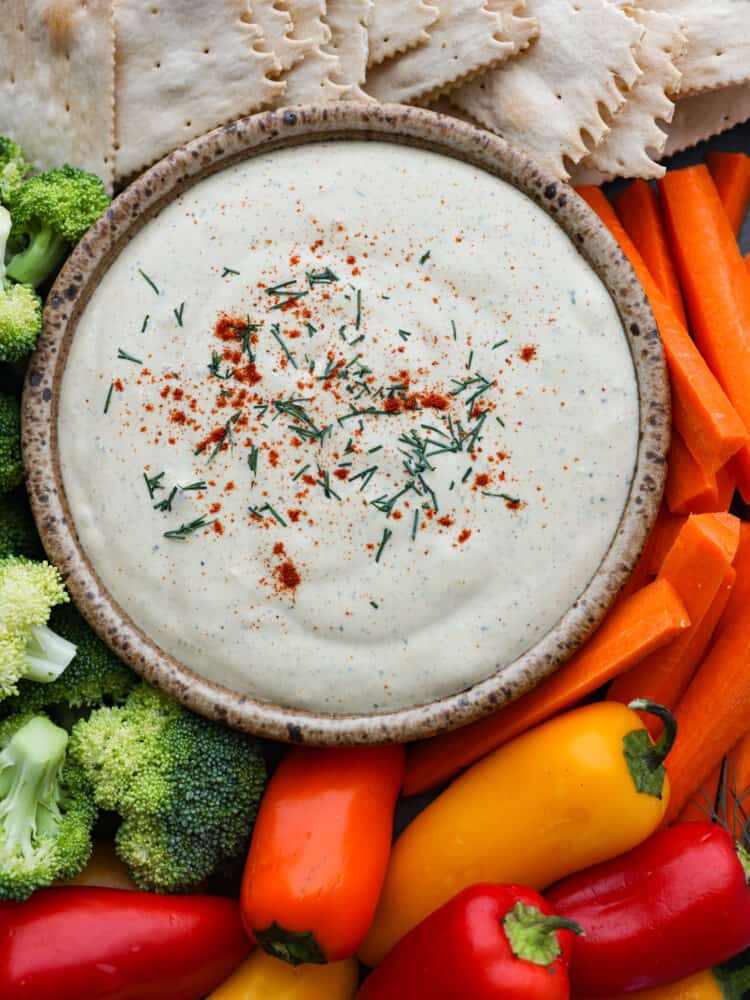 Don't underestimate cottage cheese, because once you taste this flavorful dip loaded with herbs, spices, and hard-boiled eggs (reminiscent of deviled eggs), you'll keep coming back for seconds and thirds. Top-down view of cottage cheese dip, surrounded by crackers and veggies.